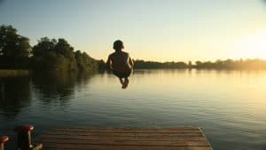 boy swimming in lake