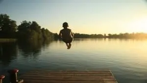 boy swimming in lake